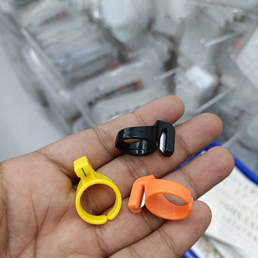 Thread cutter ring set: black, yellow and orange plastic rings with cutting slot