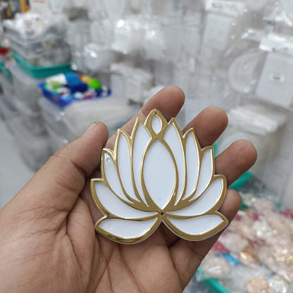White lotus acrylic tea light holder with gold trim, shown in hand