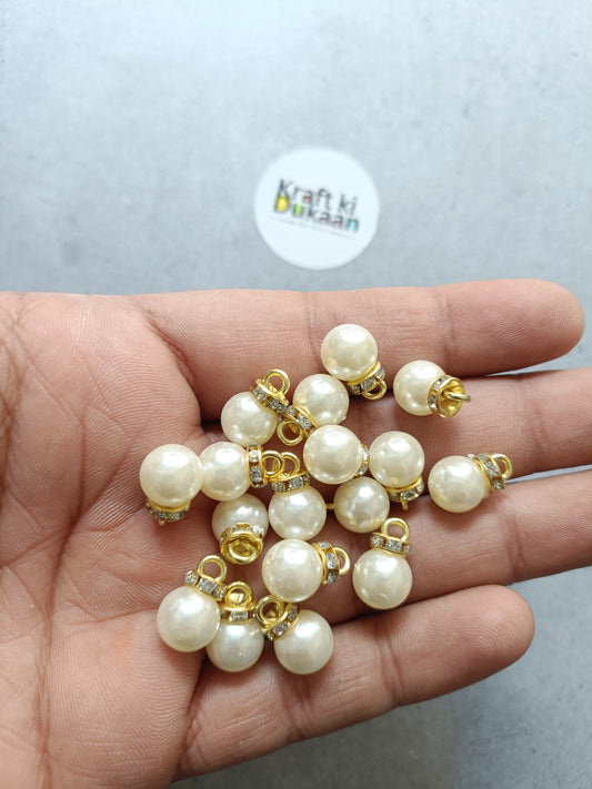 Cream pearl beads with gold caps and small rhinestone charm accents