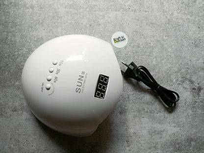 White UV LED nail lamp with digital timer display and attached power cord