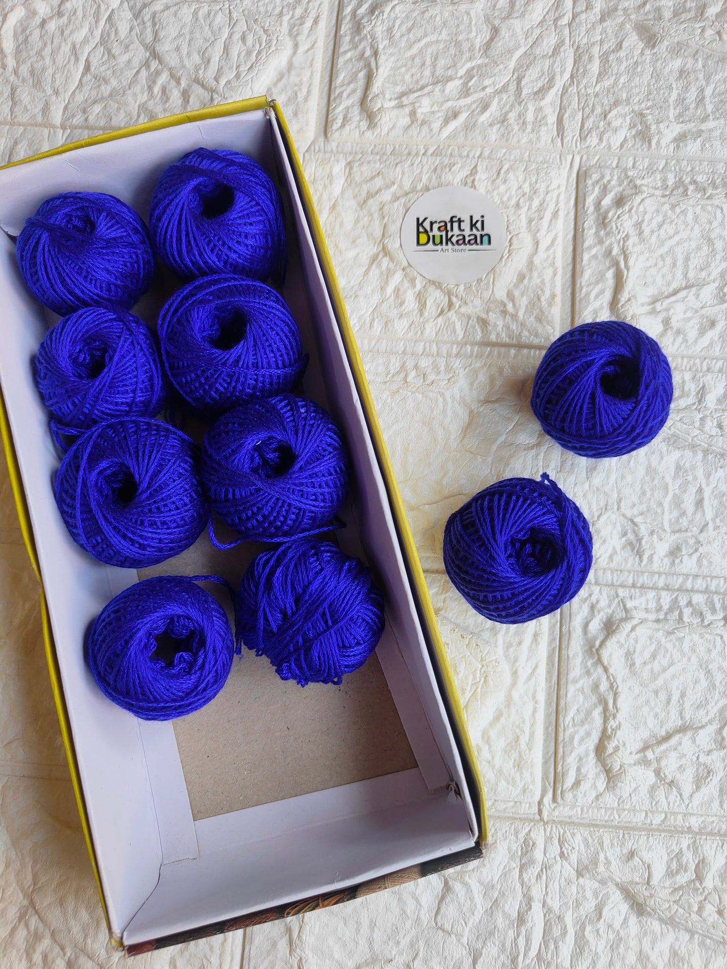 Rakhi thread roll with royal blue thread balls in open box and loose balls