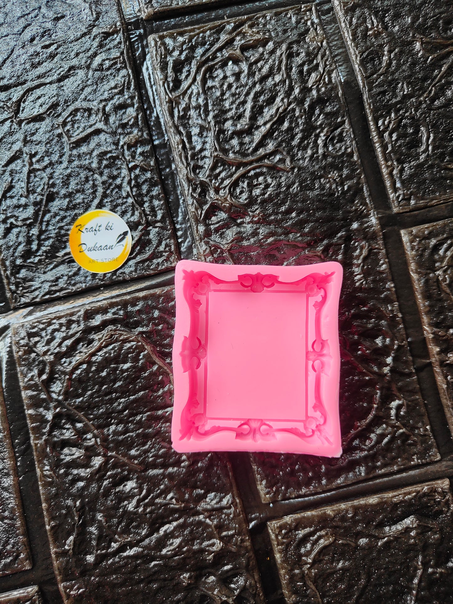 Mini square frame pink silicone mould with raised border and corner studs