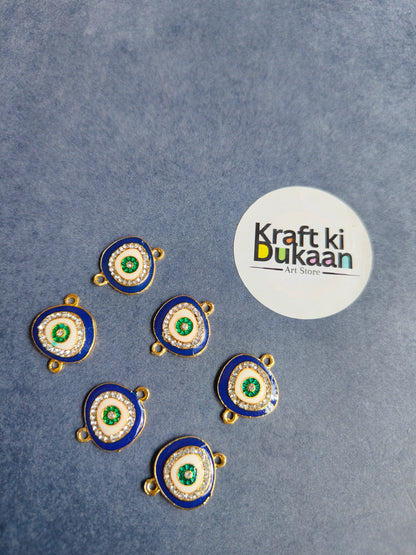 Blue and green round rakhi bracelet pendants with gold loops, laid out