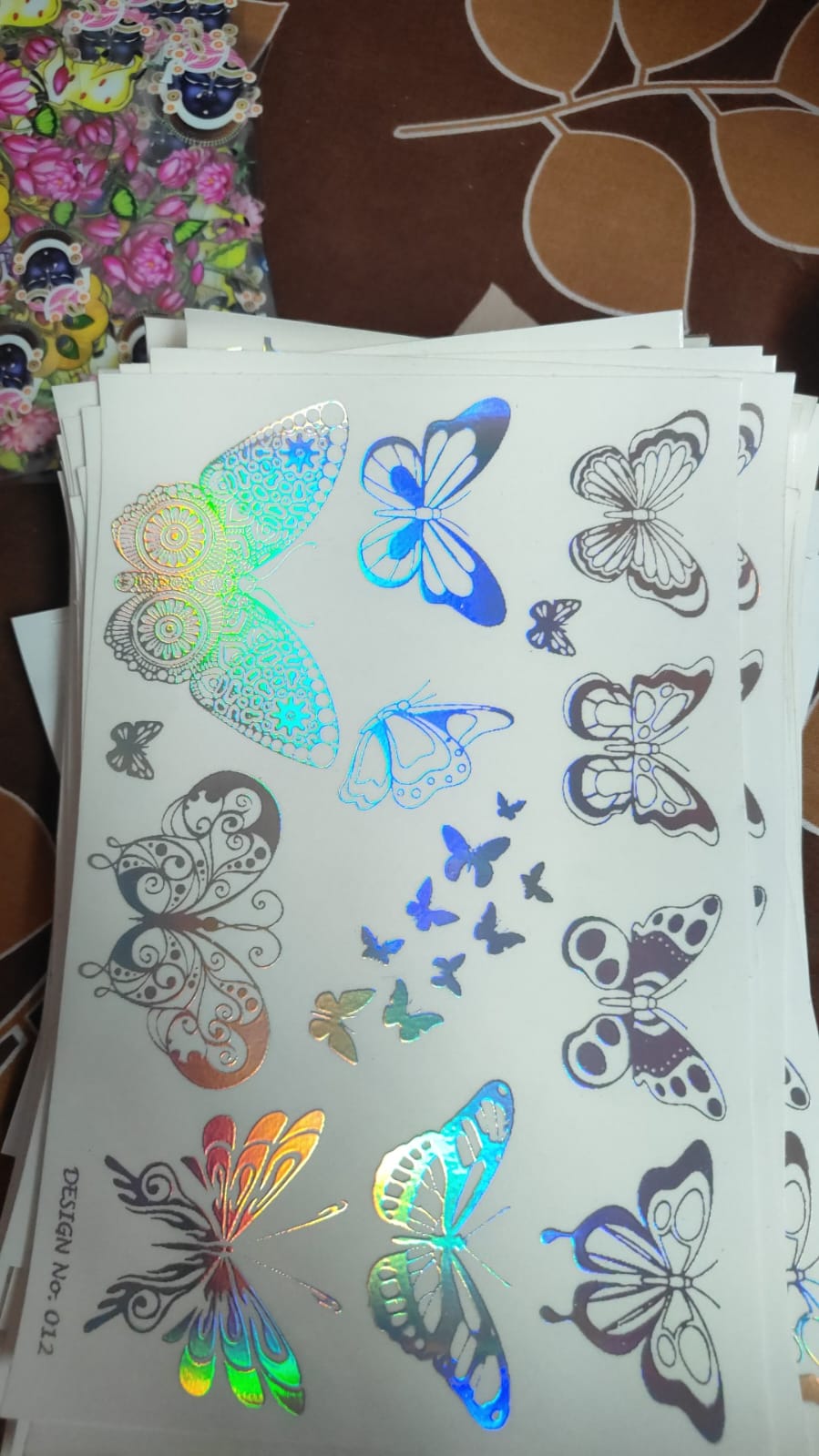 Holographic sticker sheet with butterfly and animal character decals on white backing