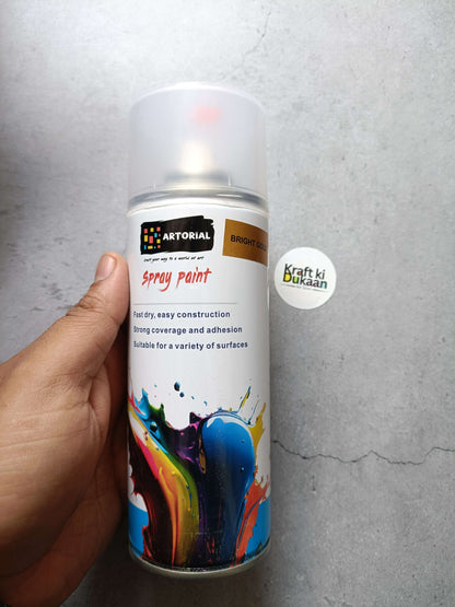 Bright gold spray paint can with colorful splatter label and “Kraft ki Dukaan” sticker