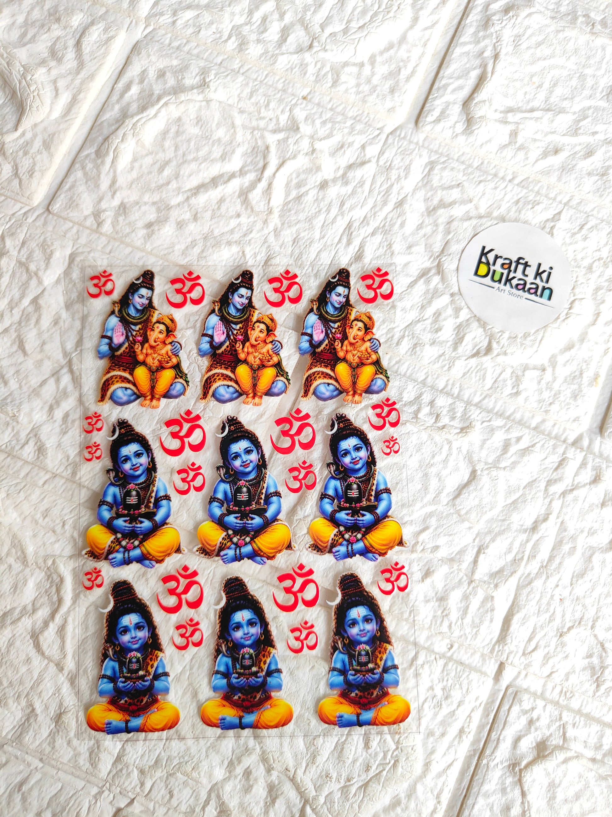 UV DTF peel-off sticker sheet with 3 blue-skinned deity figures and red 'Om' icons