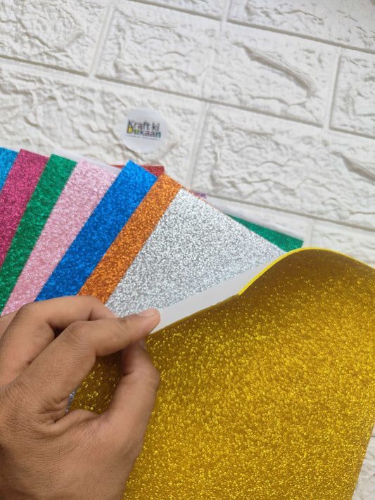 A4 glitter foam sheet, gold/yellow sparkle texture held by hand