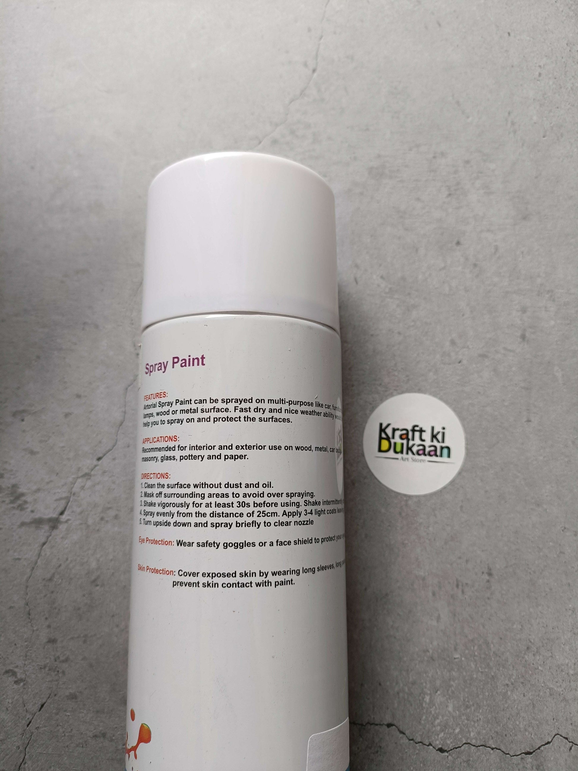 White spray paint can with side information label and round logo