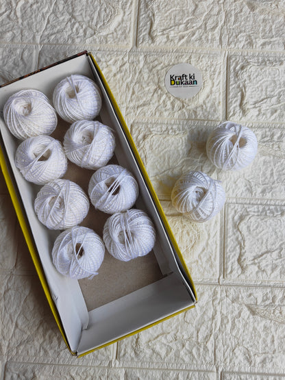 Rakhi thread roll with light gray-white thread balls in open box and loose ball