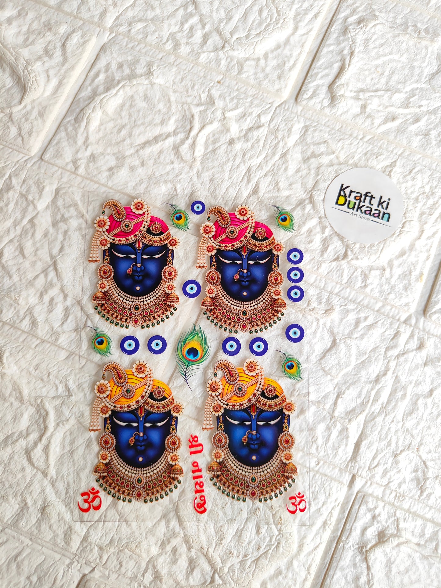Peel-off sticker sheet with four colorful circular deity designs and peacock accents