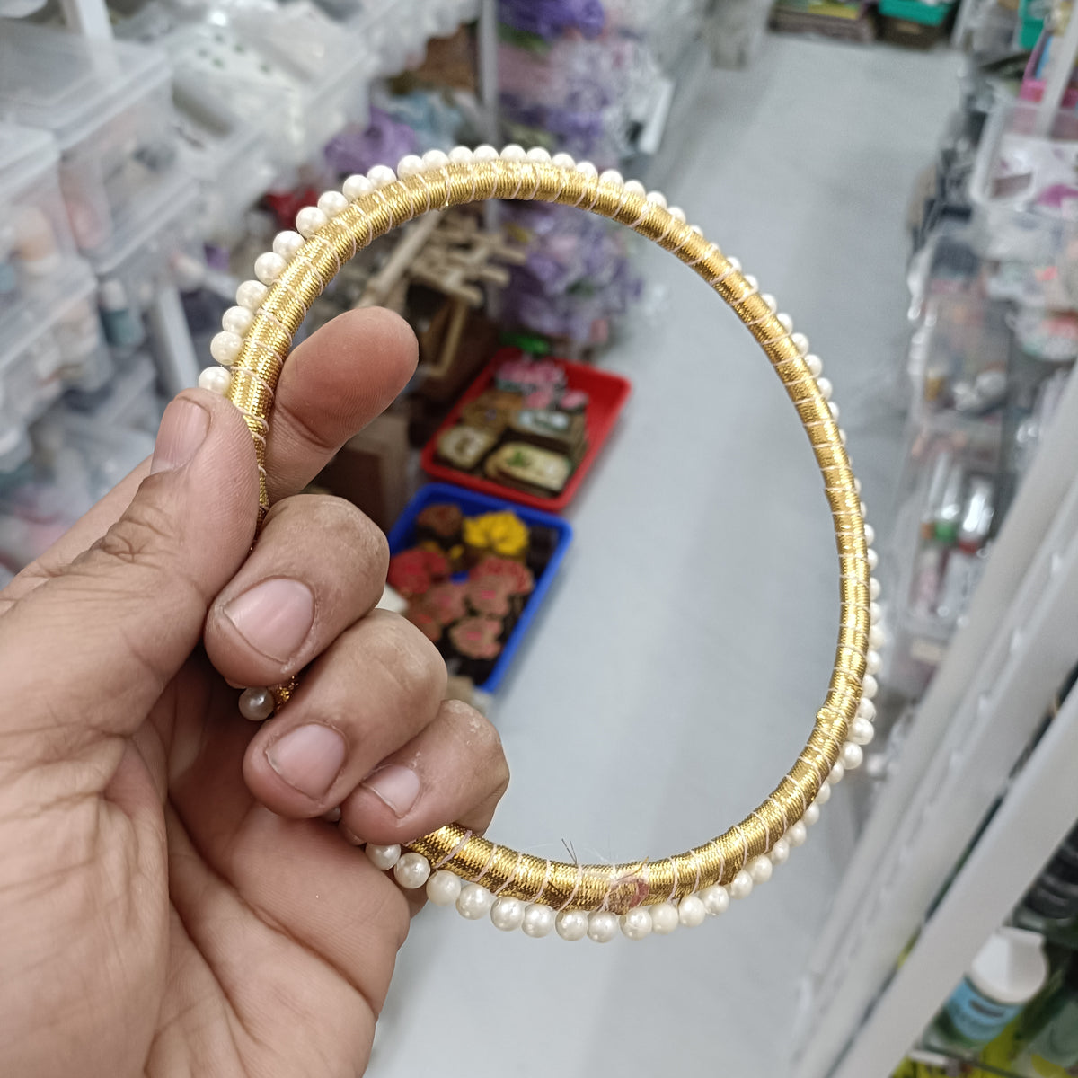 Gold-tone hoop ring with white pearl accents and small bead details