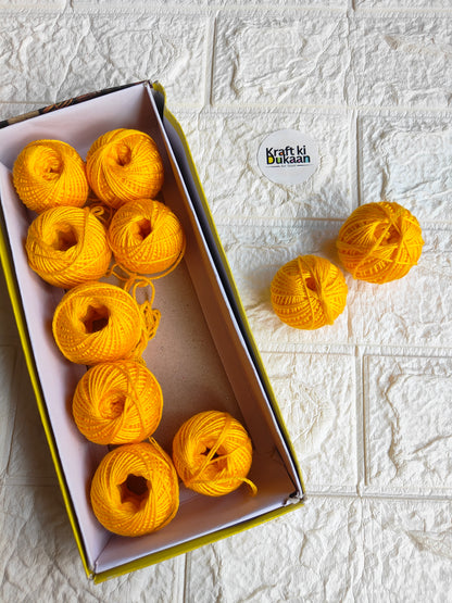 Rakhi thread roll with yellow thread balls in open box and loose ball