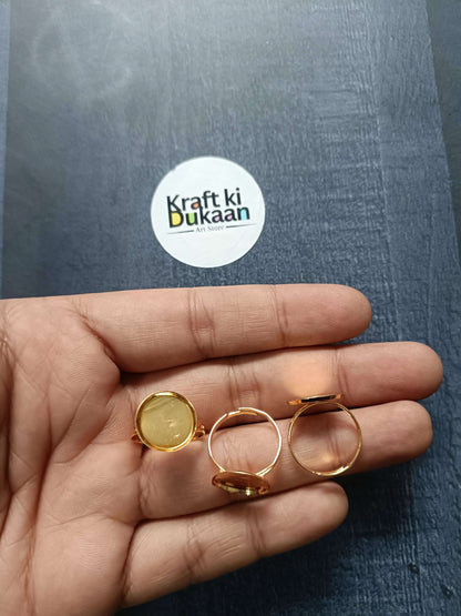 Gold-tone ring bases on palm, small round bezel settings on open bands