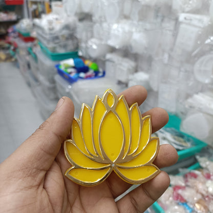 Yellow lotus acrylic tea light holder with gold trim, shown in hand