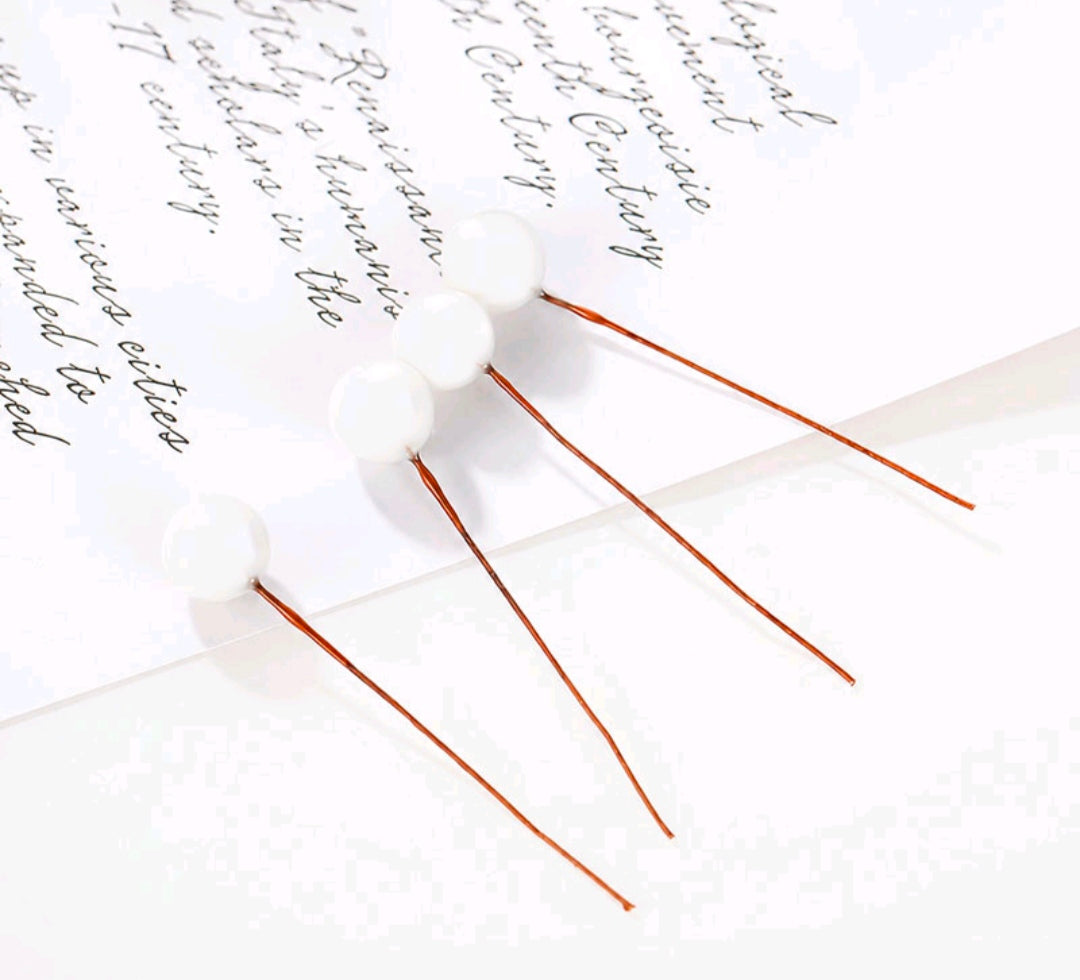 Set of 10 white faux ball toppers with thin stems and ball caps