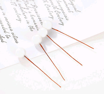 Set of 10 white faux ball toppers with thin stems and ball caps