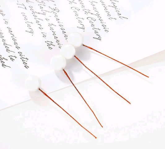 Set of 10 white faux ball toppers with thin stems and ball caps