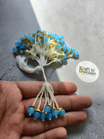 Beaded latkan with white tassel branches and blue bead clusters