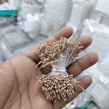 Artificial pollen bunch with taupe bristle flowers tied with white string