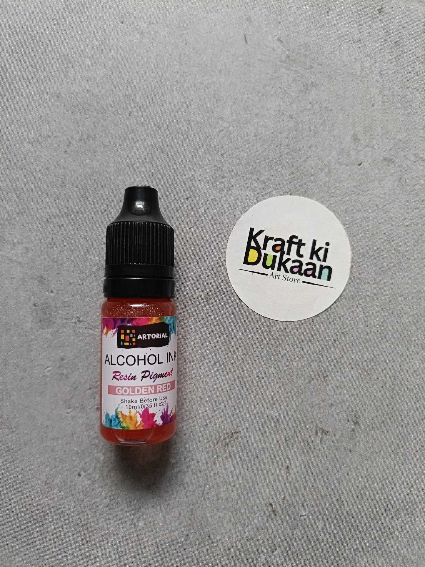 Alcohol ink bottle with black cap, gold resin pigment label