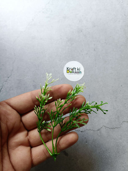 Artificial flower bunch with green stems and small white bud clusters