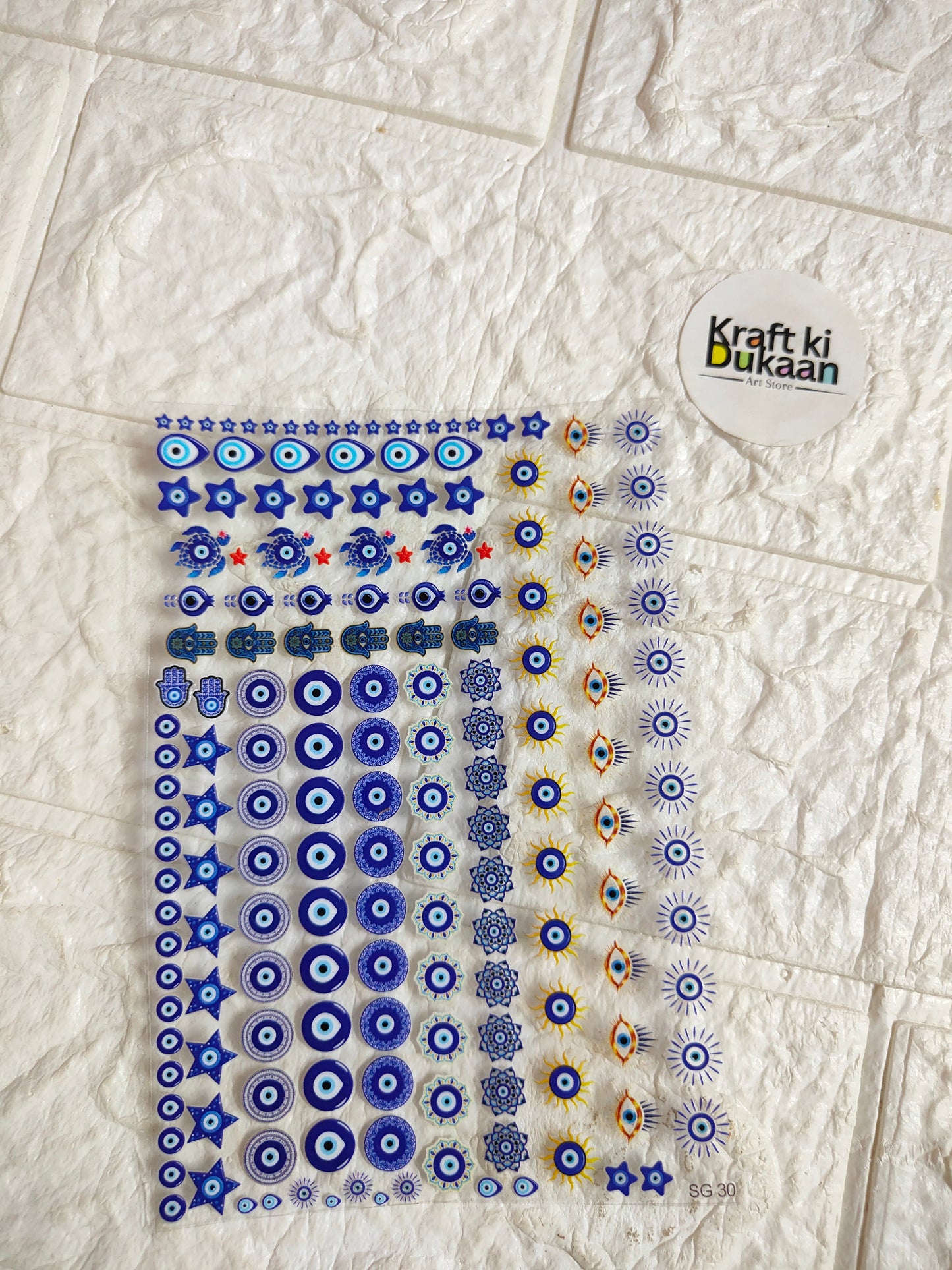UV DTF peel-off sticker sheet with blue and gold circular pattern, assorted motifs