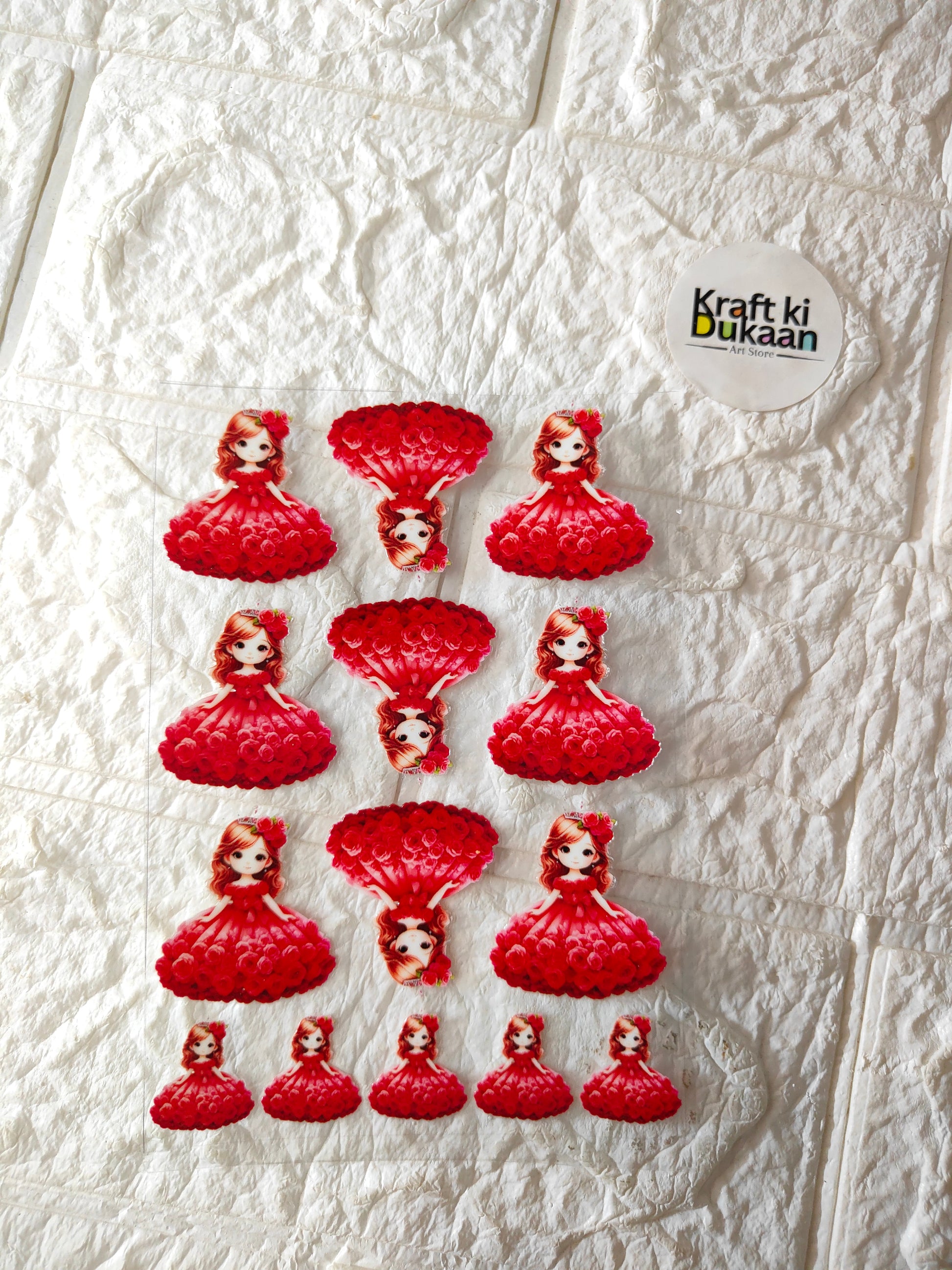 UV DTF peel-off sticker sheet with red doll dress designs, multiple on sheet