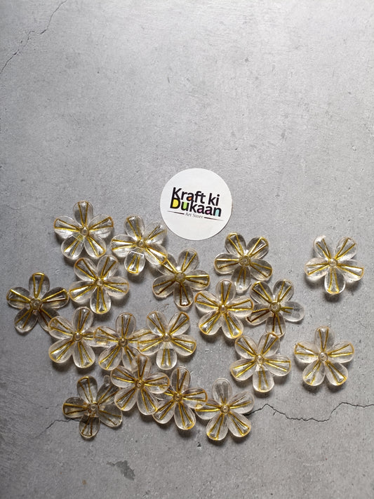 Pack of golden flower bead charms with metallic gold and clear accents laid out