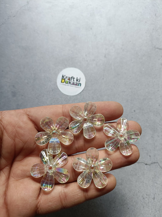Rainbow flower beads pack, clear iridescent 5-petal beads held in hand