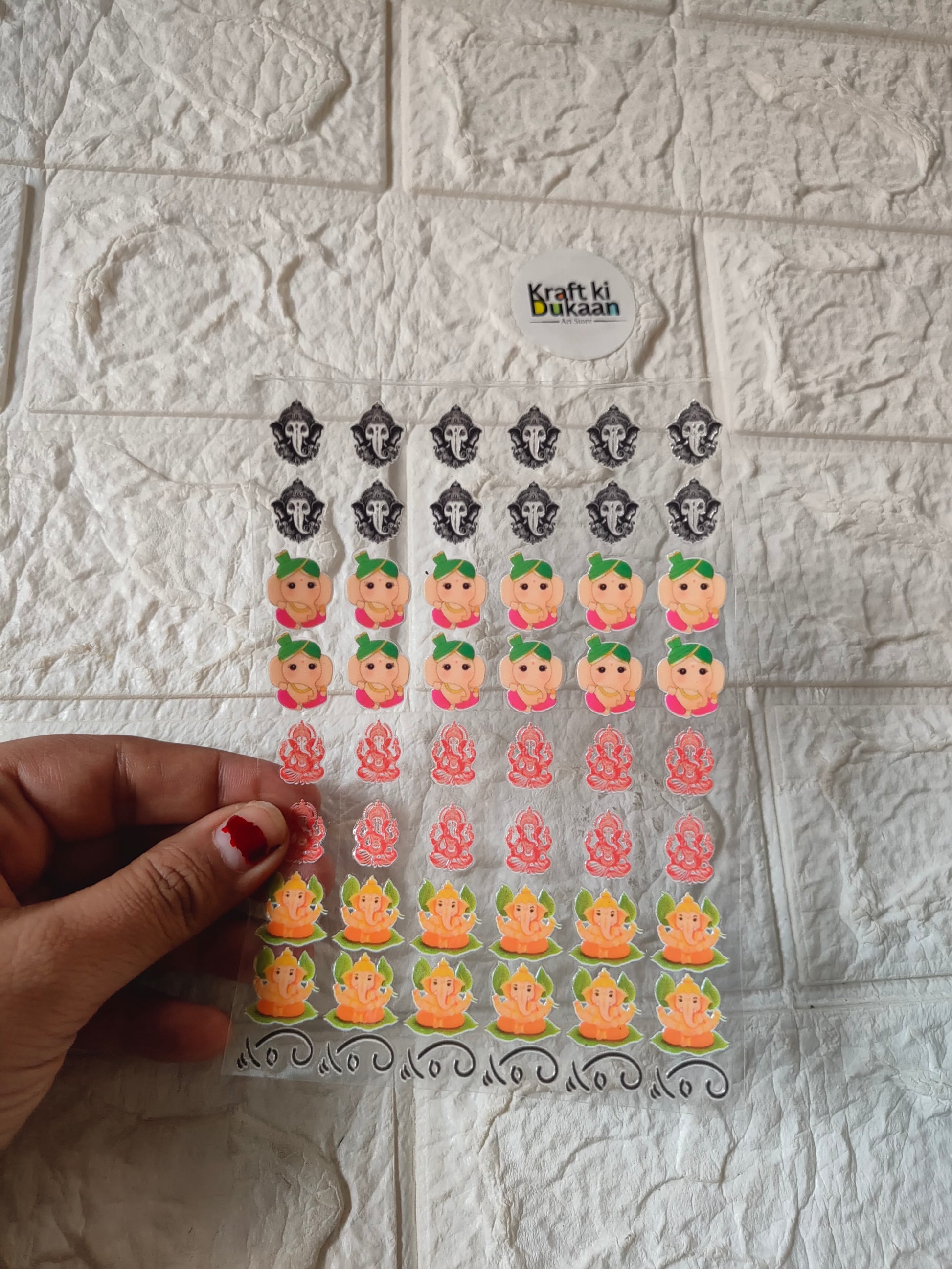 Peel-off sticker sheet with colorful cartoon faces and festive decorative icons.