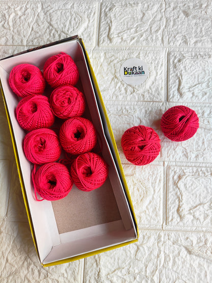 Rakhi thread spool set in vibrant pink-red, open box with several thread balls