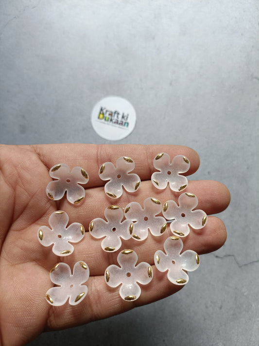 White flower beads, small round petals, in hand; pack of 50