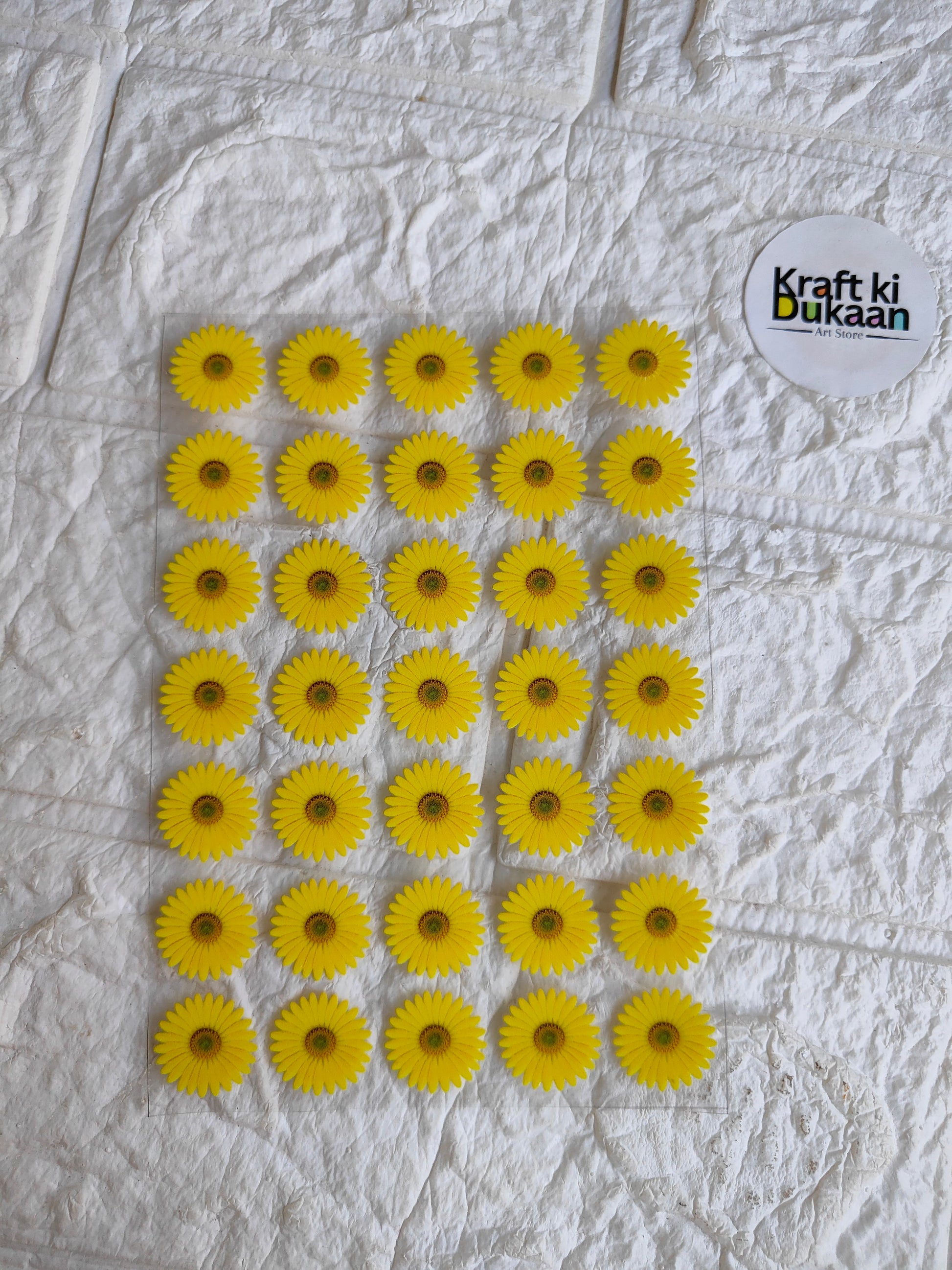 Peel-off sticker sheet with yellow sunflower-style round decals, multiple on sheet