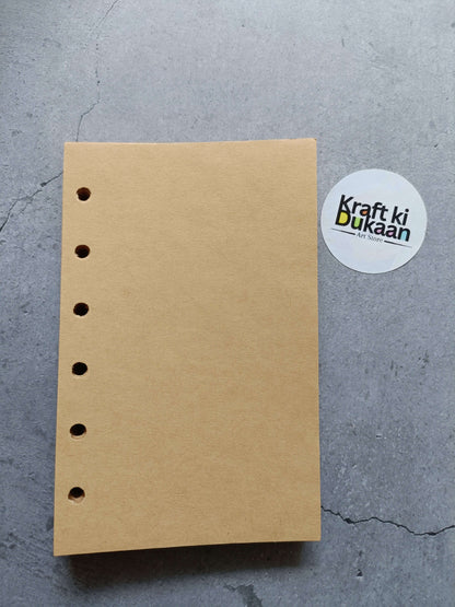 Light brown paper pages with left punched holes, flat view