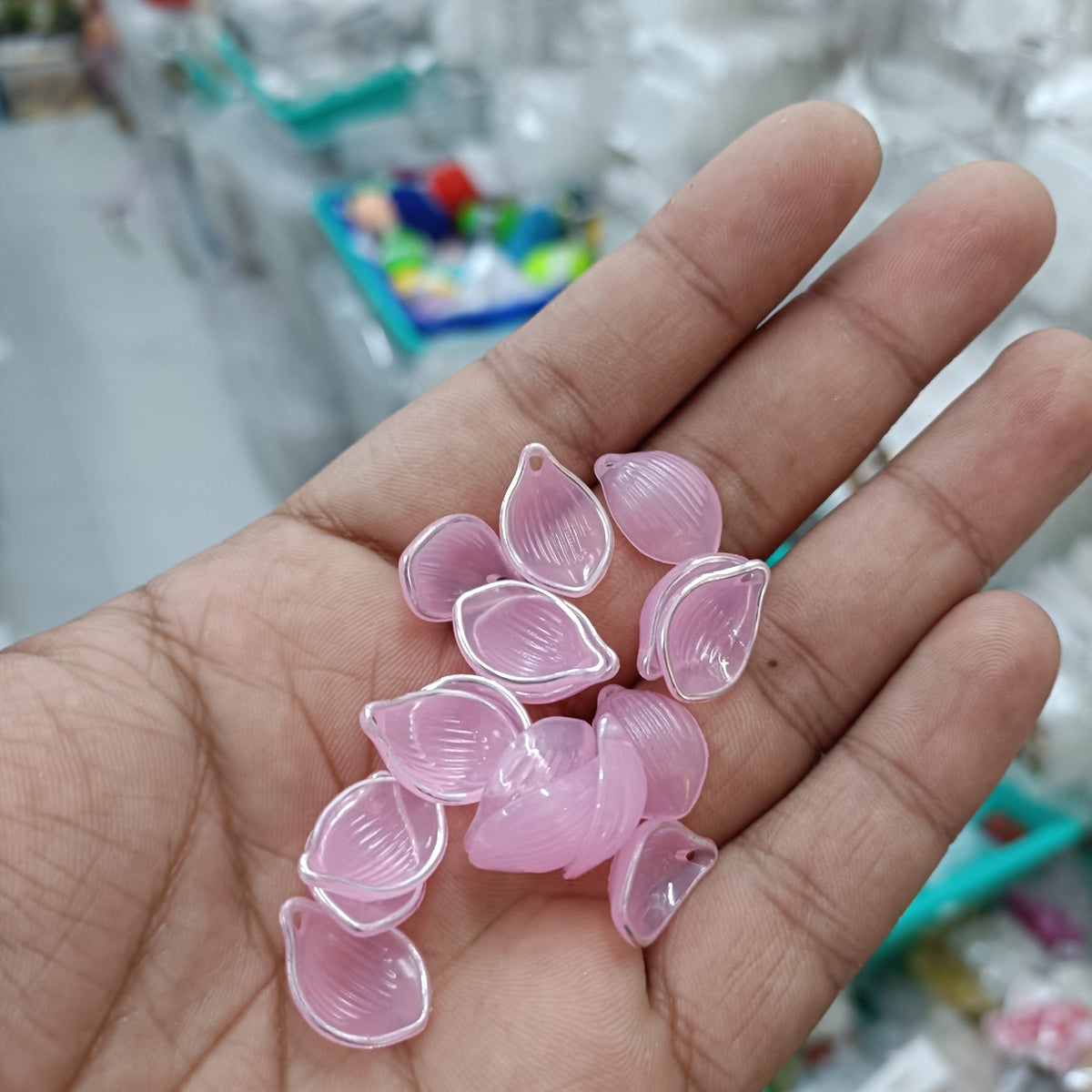 Acrylic petal beads, translucent pink, assorted pieces in hand