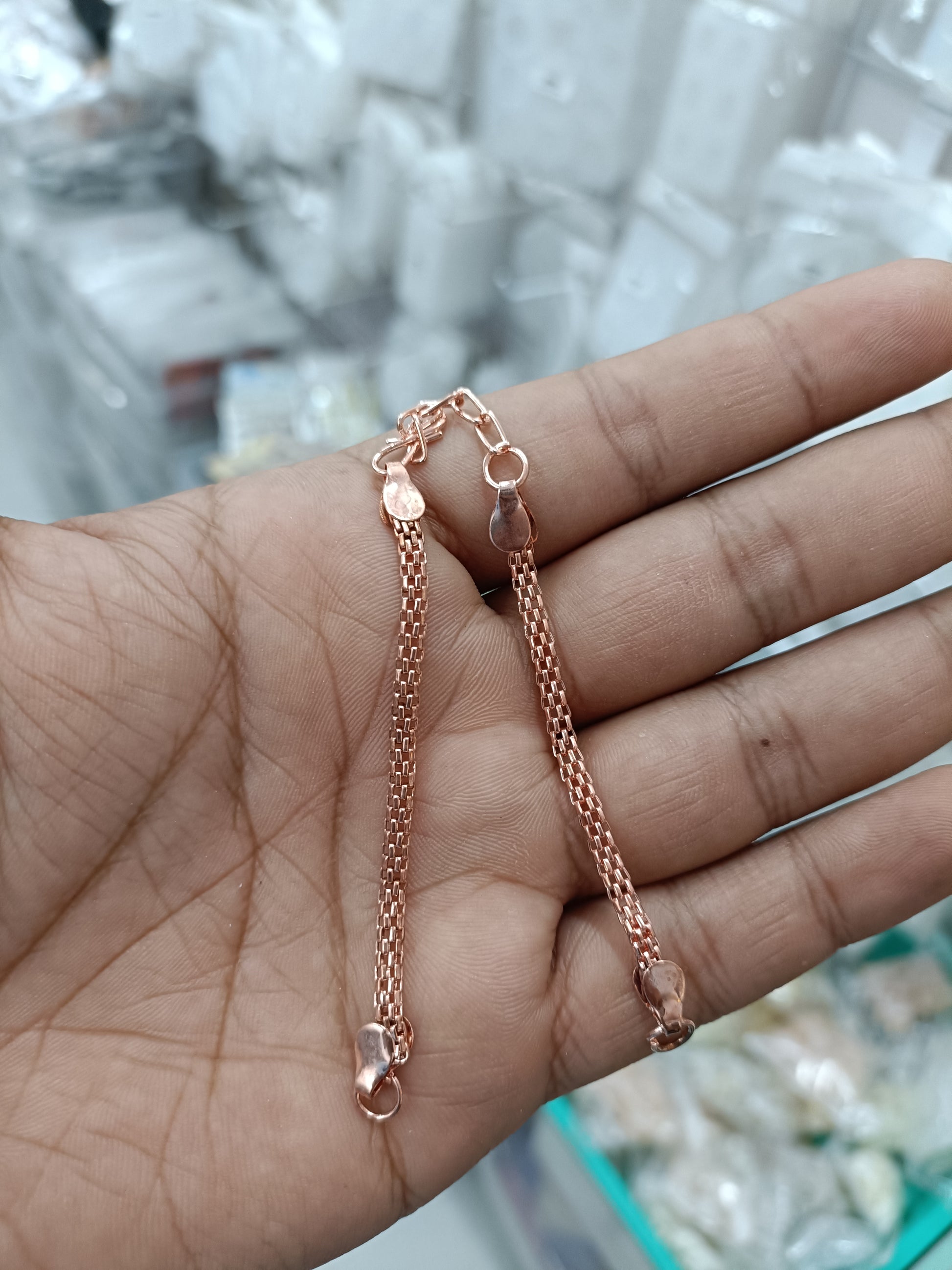 Rose gold chain rakhi bracelets with bead accents and ring clasp details