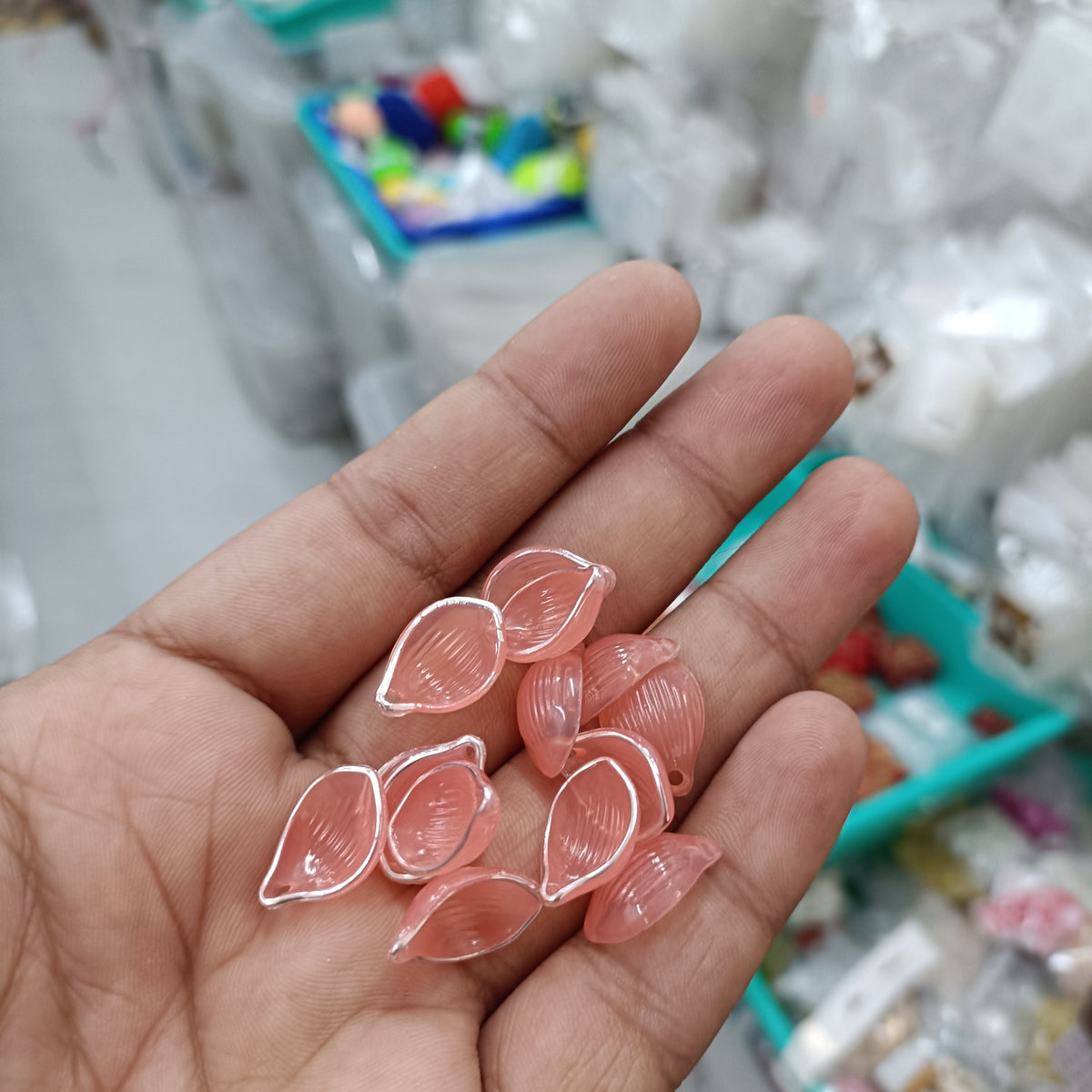 Acrylic petal beads, translucent peach-pink, assorted pieces in hand