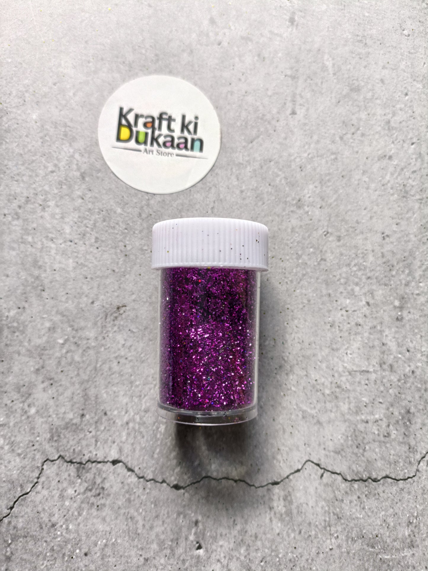 Purple chunky glitter powder jar with white ribbed lid.