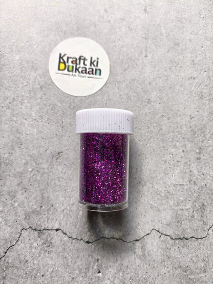 Purple chunky glitter powder jar with white ribbed lid.
