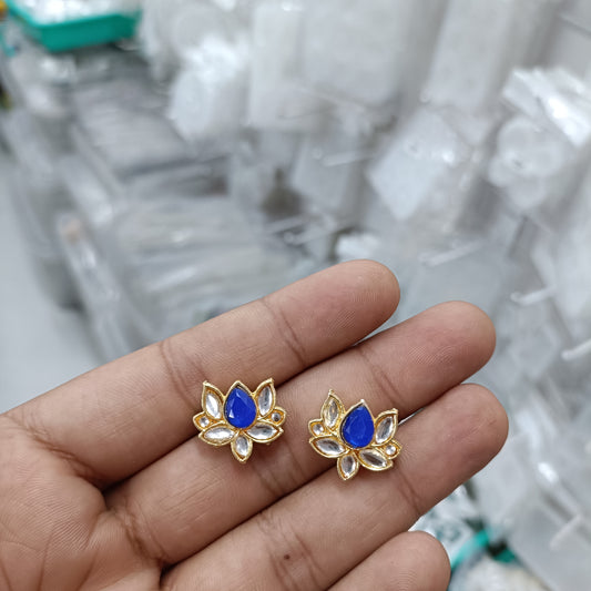 Gold-tone lotus stud earrings with blue center stones and white petal detailing