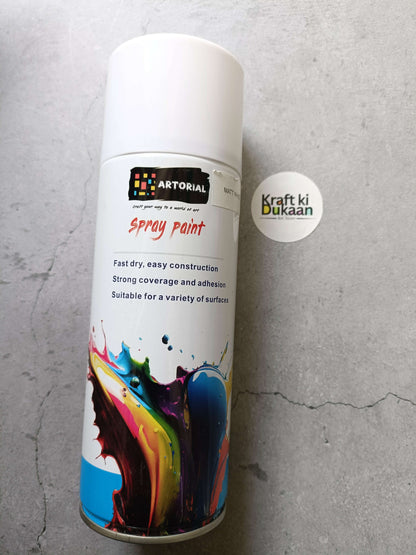 Matt white spray paint can with colorful splatter artwork and “Kraft ki Dukaan” sticker