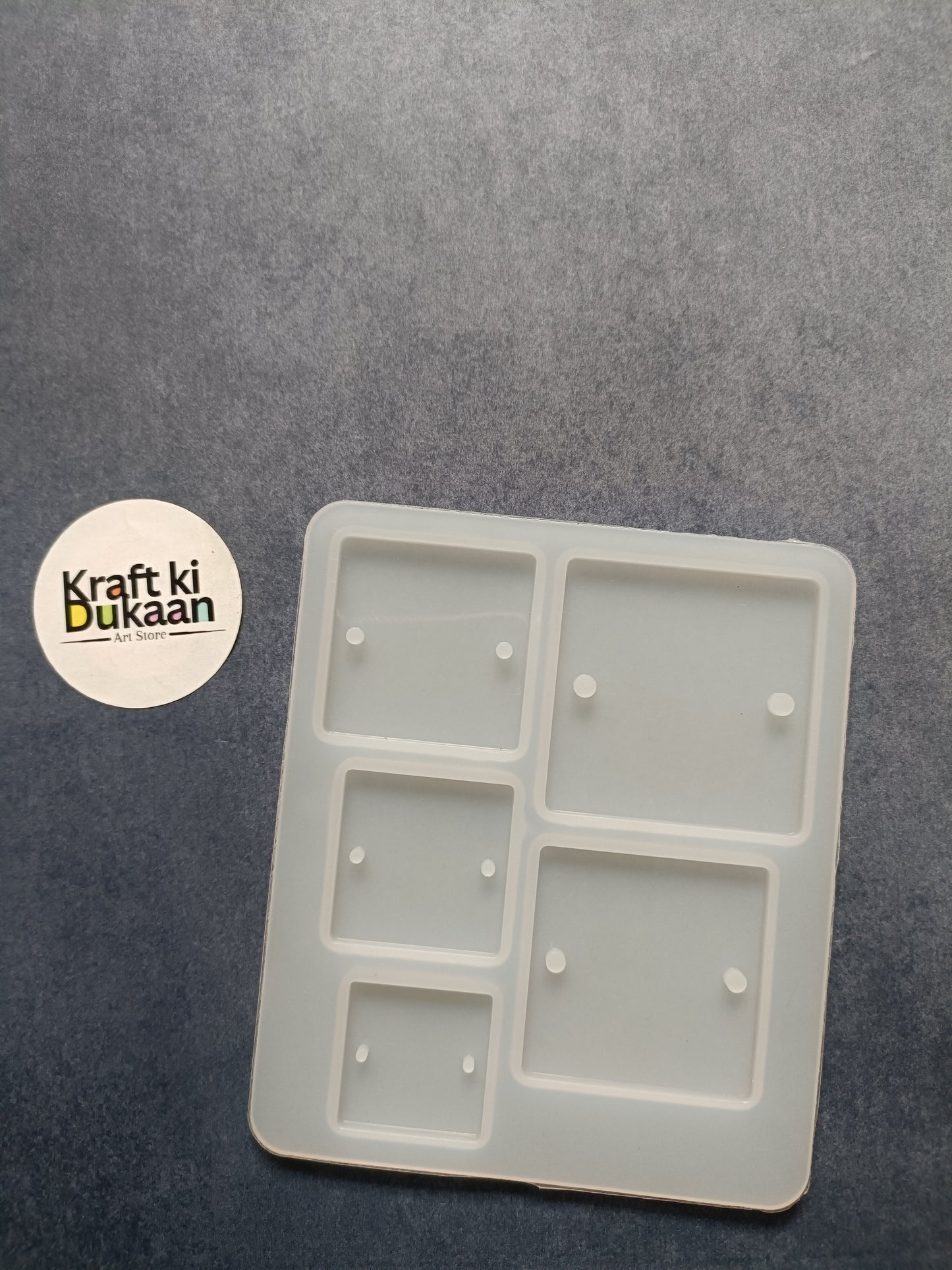 Rectangle rakhi mould with five square cavities, light gray plastic tray
