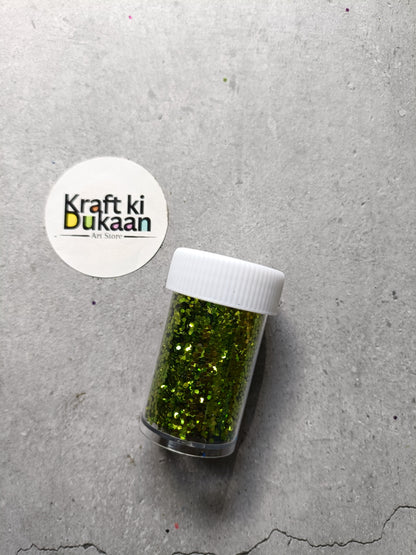 Hexagon glitter jar with yellow-green glitter in a small white-lidded bottle