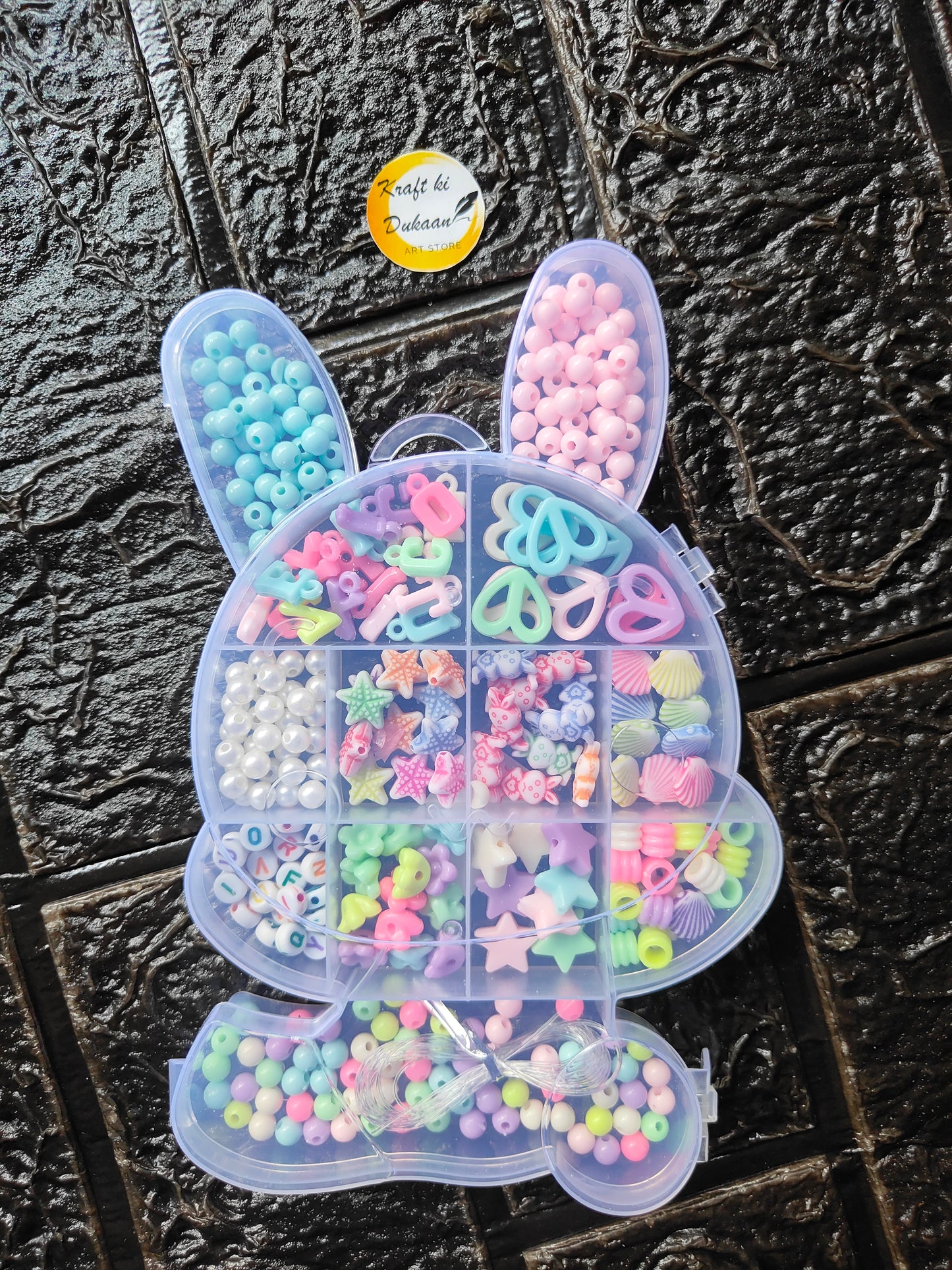 DIY bracelet bead kit in clear heart organizer, pastel round beads and charms in sections