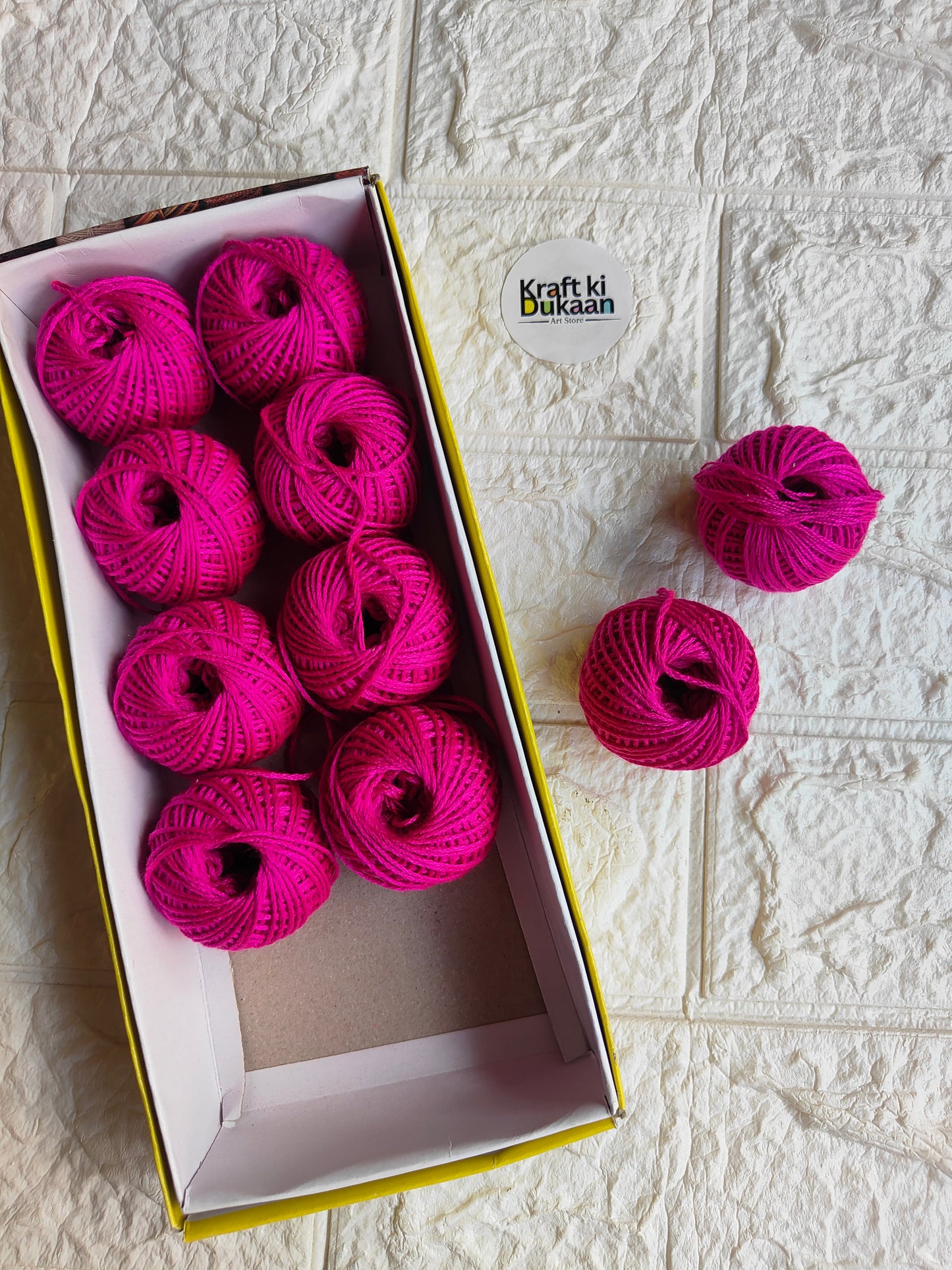 Rakhi thread spool set in hot pink, open box with multiple thread spools and extra spool