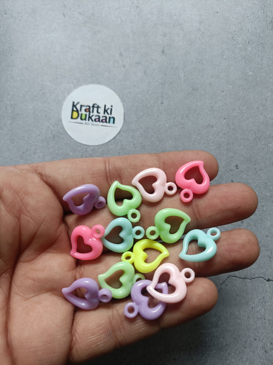 Heart-shaped rakhi bracelet beads, multicolor resin pieces in hand