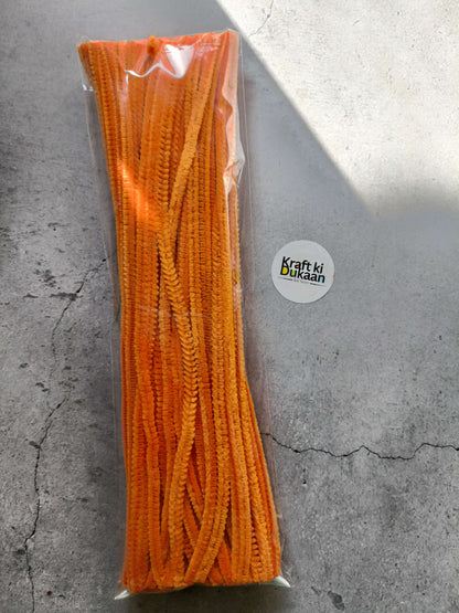 Orange pipe cleaners bundle in clear packaging, fuzzy chenille texture.