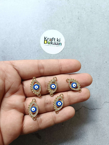 Gold-tone evil eye bracelet charms, set of five, on hand