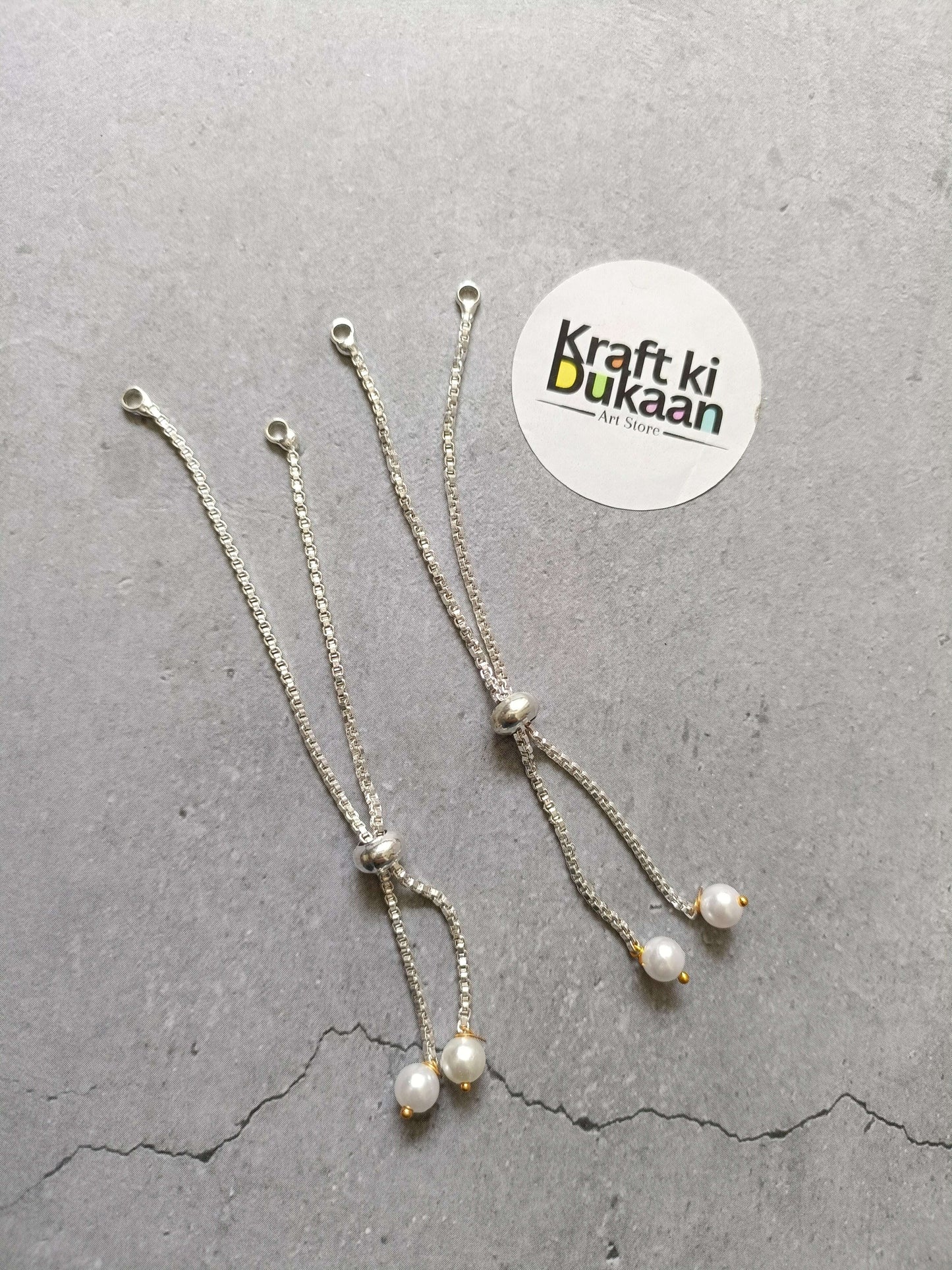 Silver-tone chain bracelet with pearl drop charms and small clasp
