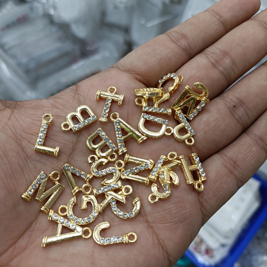 Gold alphabet pendant charms pack with rhinestone-studded letter charms in mixed shapes